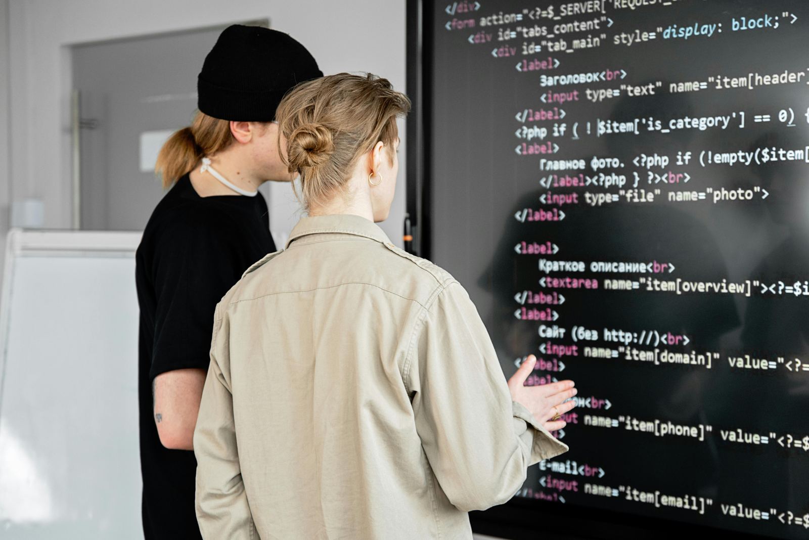 Developers reviewing code on a large screen